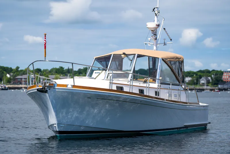 Slide: The Image of 2000 Grand Banks Eastbay 43 Ex yacht on calm water. - 3