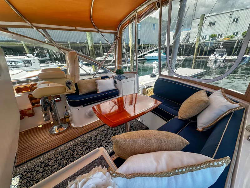 Slide: The Image of Luxurious interior of 2000 Grand Banks Eastbay 43 Ex yacht with plush seating and wooden table. - 35