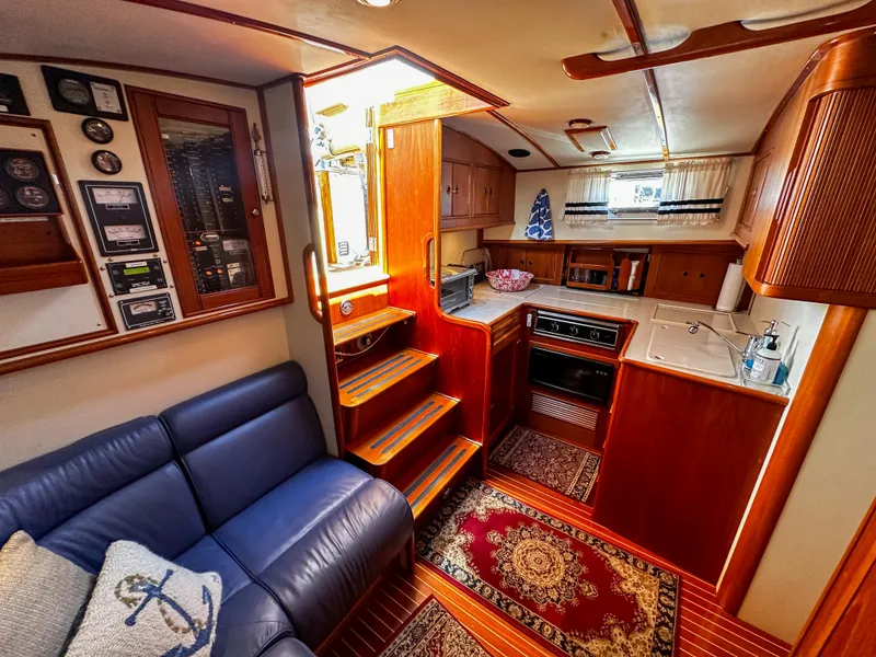 Slide: The Image of Interior of 2000 Grand Banks Eastbay 43 Ex yacht with kitchen and seating area. - 44