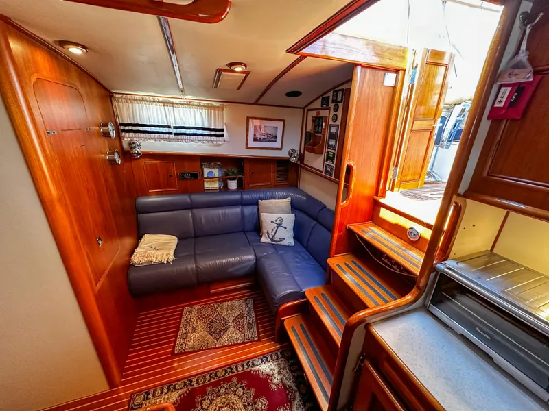 Slide: The Image of Interior of 2000 Grand Banks Eastbay 43 Ex with cozy seating area and wooden finishes. - 46