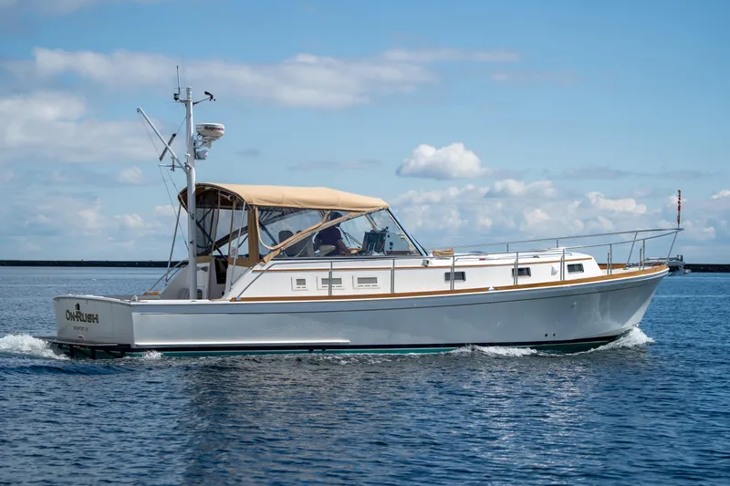Slide: The Image of 2000 Grand Banks Eastbay 43 Ex cruising on calm waters under a clear sky. - 5