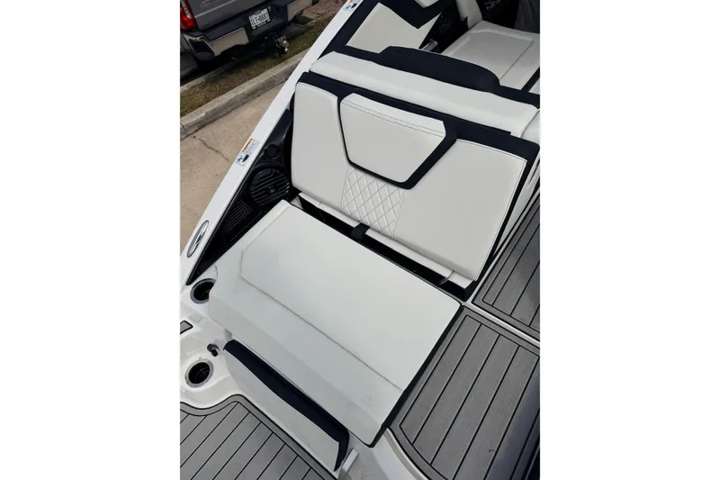 Slide: The Image of 2026 Yamaha Boats 252SD interior seating with sleek white and black design. - 10