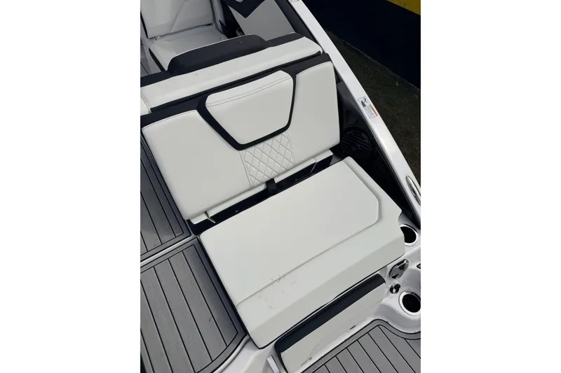 Slide: The Image of 2026 Yamaha Boats 252SD interior seating with white upholstery and modern design. - 11