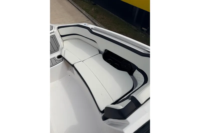 Slide: The Image of 2026 Yamaha Boats 252SD interior seating with white upholstery and cup holders. - 14