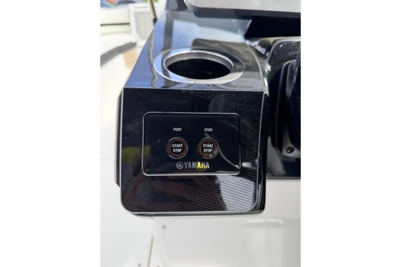 Slide: The Image of Control panel of 2026 Yamaha Boats 252SD with start/stop buttons. - 23