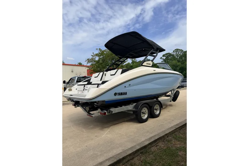 Slide: The Image of 2026 Yamaha Boats 252SD on trailer, sleek design, parked outdoors. - 4