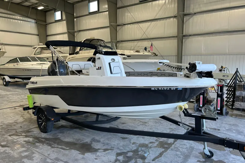 The Image of 2020 Wellcraft 162 Fisherman boat on trailer in indoor storage facility. - 1