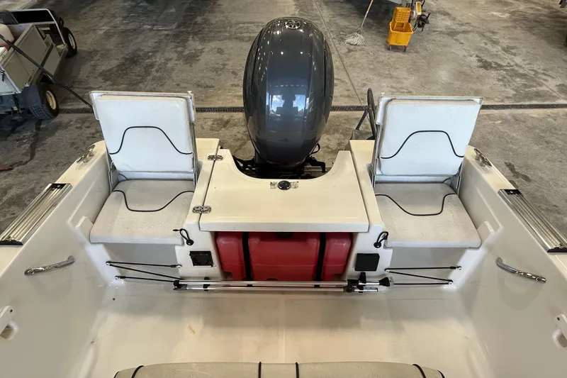 Slide: The Image of 2020 Wellcraft 162 Fisherman boat interior with motor and seating. - 10