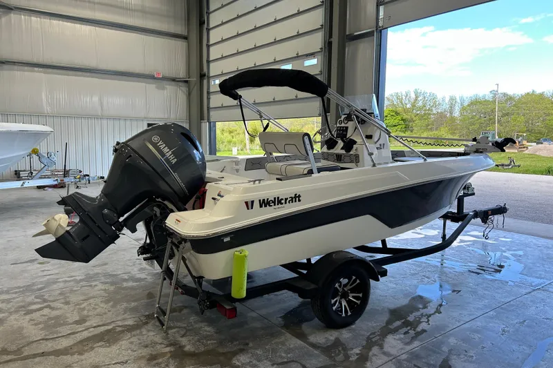 Slide: The Image of 2020 Wellcraft 162 Fisherman boat with Yamaha outboard motor in a garage. - 3