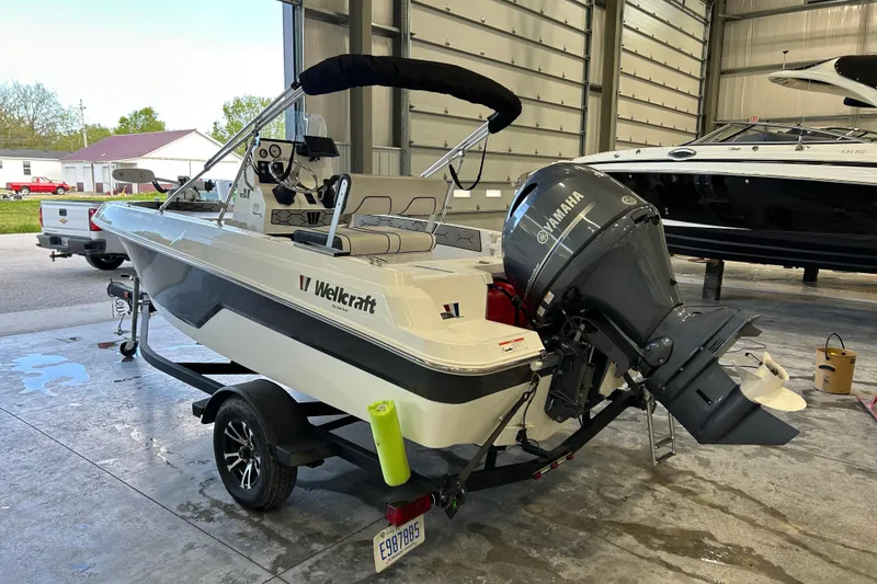 Slide: The Image of 2020 Wellcraft 162 Fisherman boat with Yamaha outboard motor in a garage setting. - 4