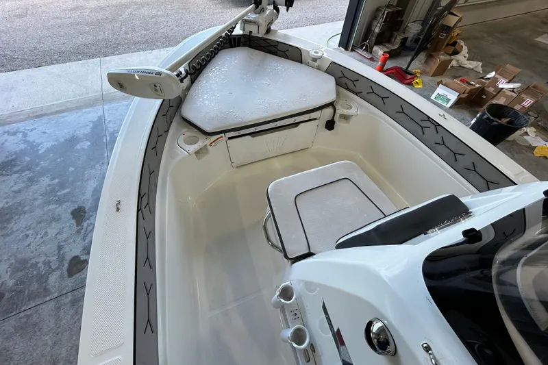 Slide: The Image of 2020 Wellcraft 162 Fisherman boat interior with seating and storage in a garage setting. - 7
