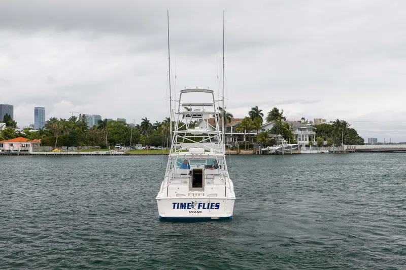 Slide: The Image of 2006 Cabo 35 Express boat named "Time Flies" on water near Miami shoreline. - 10