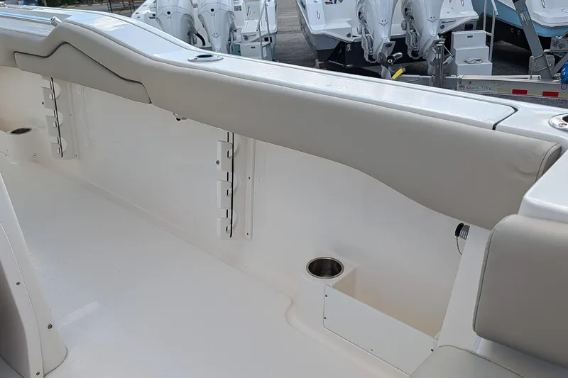 Slide: The Image of 2023 Key West 263 FS boat interior with cushioned seating and cup holder. - 11