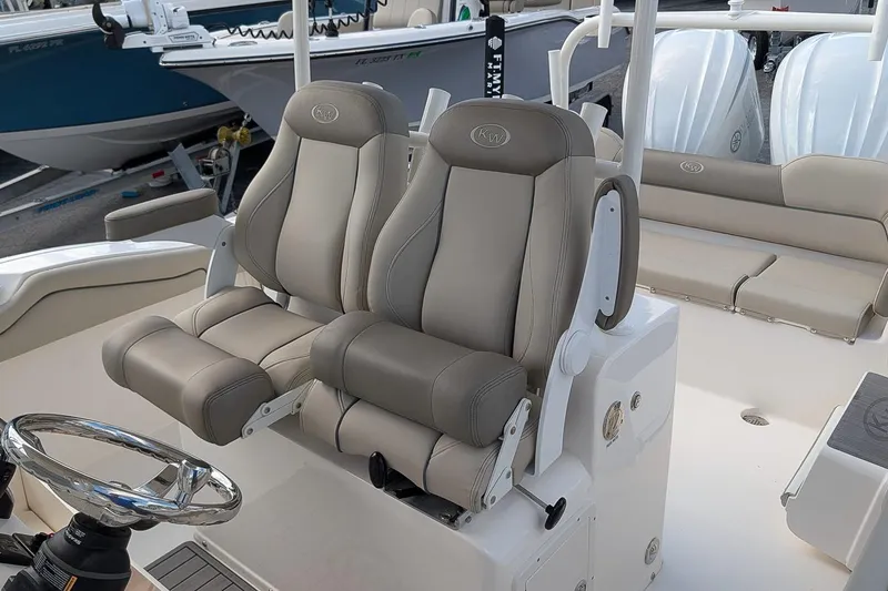 Slide: The Image of 2023 Key West 263 FS boat interior with dual captain's chairs and steering wheel. - 12