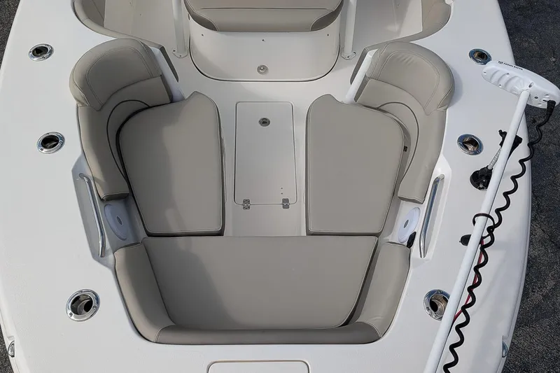 Slide: The Image of 2023 Key West 263 FS boat interior with cushioned seating and storage compartments. - 18