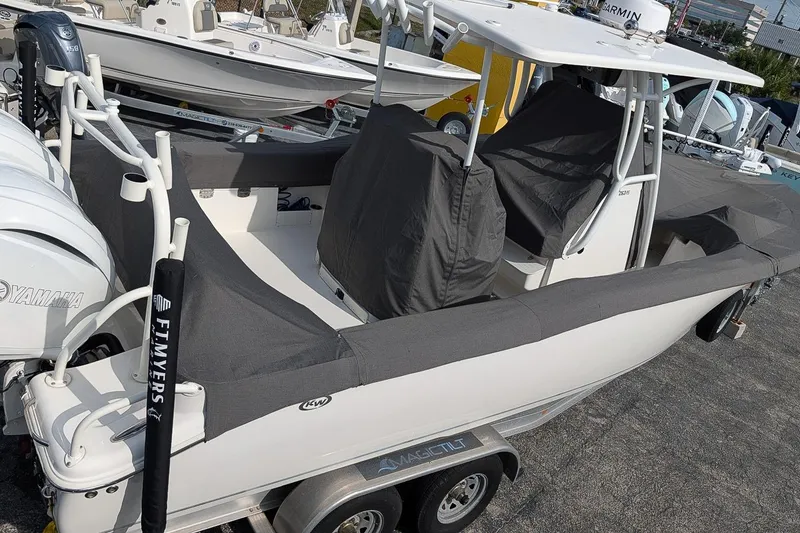 Slide: The Image of 2023 Key West 263 FS boat with Yamaha engines, covered and on a trailer. - 22
