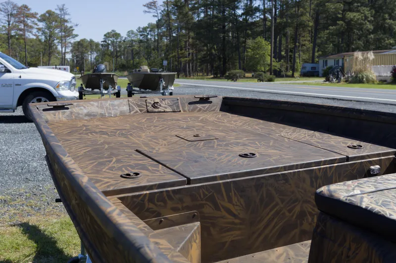 Slide: The Image of 2026 G3 Gator Tough 17 CC boat with camouflage design, parked near a road. - 10
