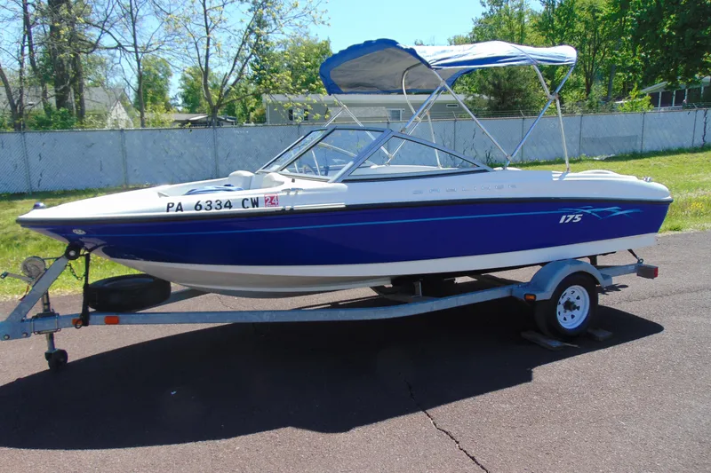 The Image of 2006 Bayliner 175 Bowrider boat on trailer with blue and white exterior. - 1