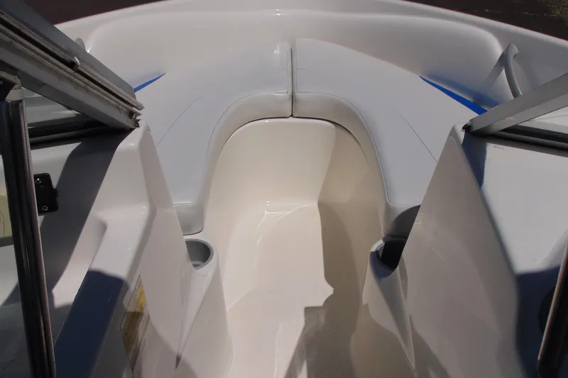 Slide: The Image of 2006 Bayliner 175 Bowrider interior with white seating and cup holders. - 12
