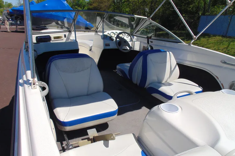 Slide: The Image of 2006 Bayliner 175 Bowrider interior with white and blue seating, steering wheel, and dashboard. - 6
