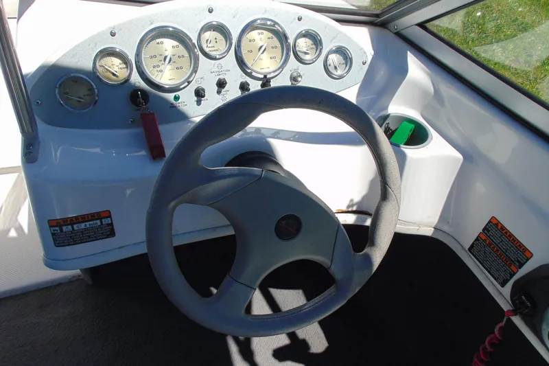 Slide: The Image of Dashboard of a 2006 Bayliner 175 Bowrider boat with steering wheel and gauges. - 8