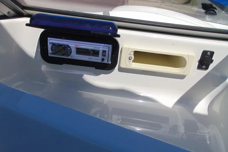 Slide: The Image of 2006 Bayliner 175 Bowrider dashboard with stereo system and storage compartment. - 9