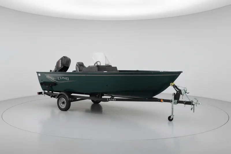The Image of 2026 Lund 1650 Angler SS fishing boat on trailer in studio setting. - 0
