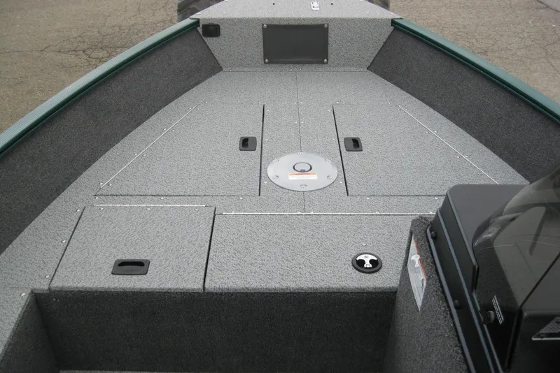 Slide: The Image of 2026 Lund 1650 Angler SS boat interior with storage compartments and textured flooring. - 10