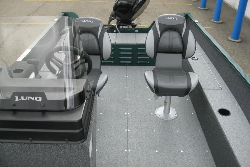 Slide: The Image of 2026 Lund 1650 Angler SS boat interior with steering console and seating. - 12
