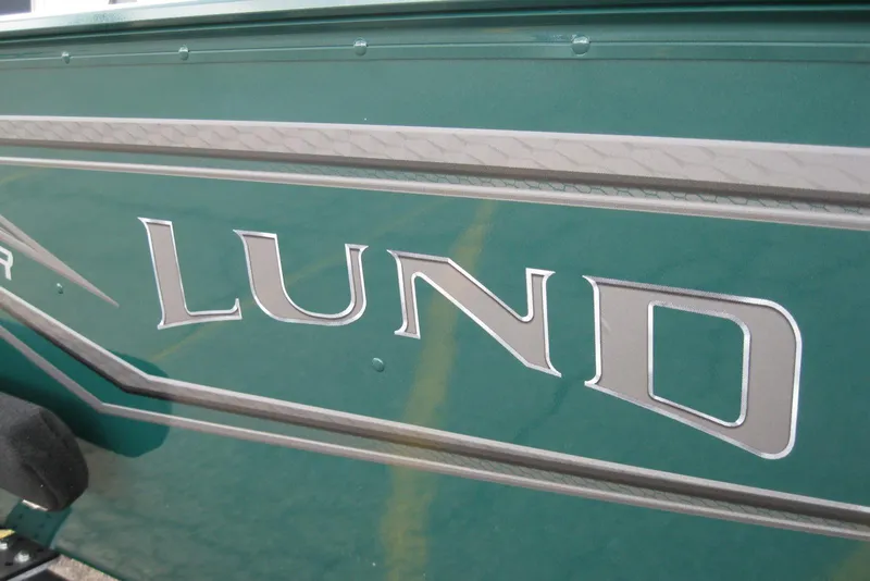 Slide: The Image of 2026 Lund 1650 Angler SS boat logo on green exterior. - 3