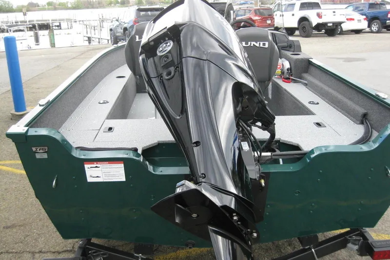 Slide: The Image of 2026 Lund 1650 Angler SS boat with outboard motor, parked on trailer. - 6