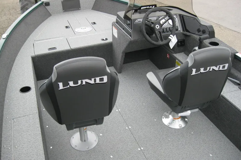 Slide: The Image of 2026 Lund 1650 Angler SS boat interior with steering console and two seats. - 7