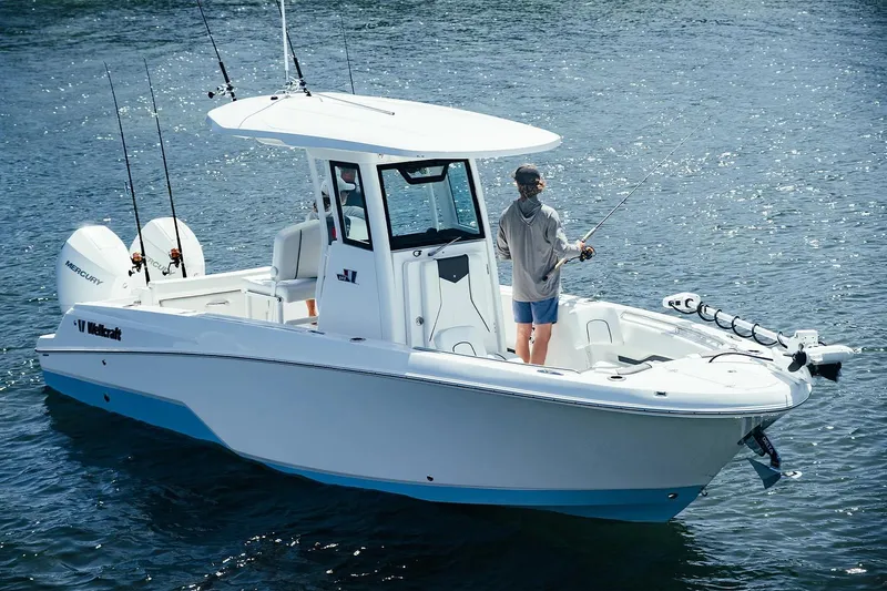 The Image of 2026 Wellcraft 243 Fisherman boat on water, person fishing on deck. - 0