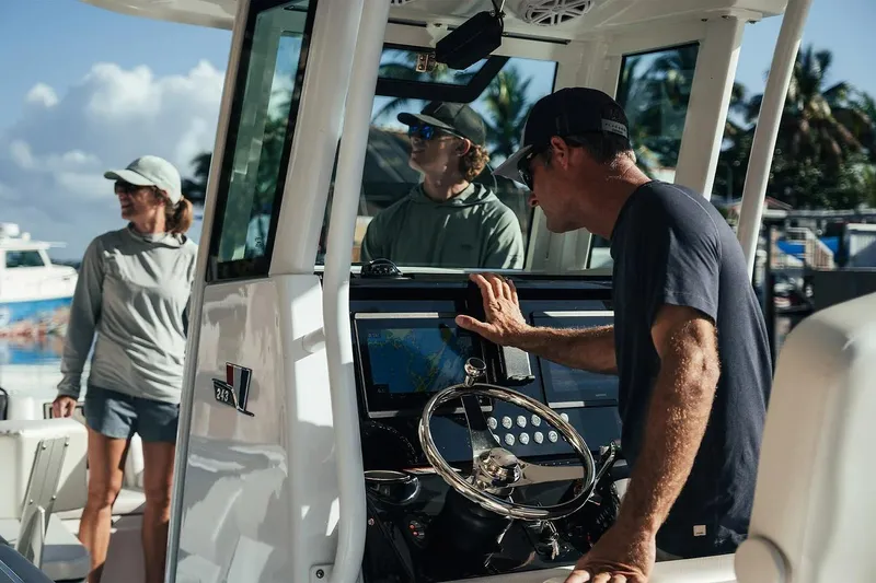 Slide: The Image of People on a 2026 Wellcraft 243 Fisherman boat, navigating with modern equipment. - 6