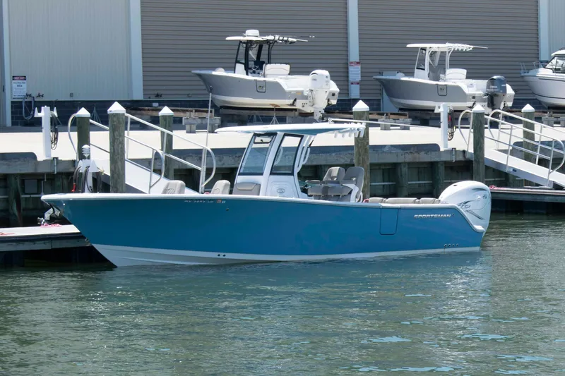 The Image of 2023 Sportsman Heritage 261 Center Console boat docked at marina. - 0