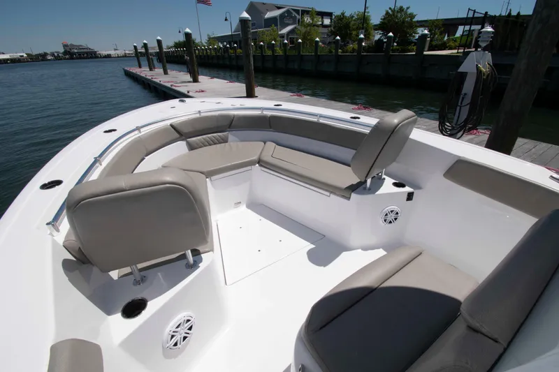 Slide: The Image of 2023 Sportsman Heritage 261 Center Console boat with spacious seating and dockside view. - 11