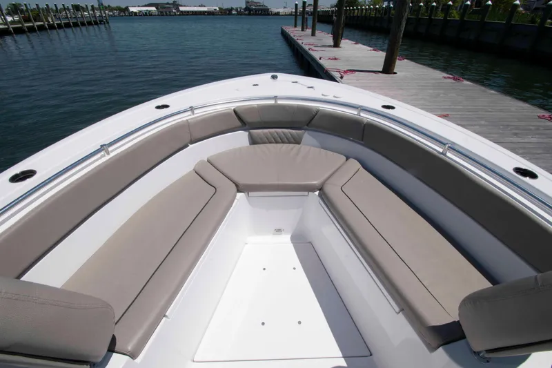 Slide: The Image of 2023 Sportsman Heritage 261 Center Console boat with spacious seating at the dock. - 12