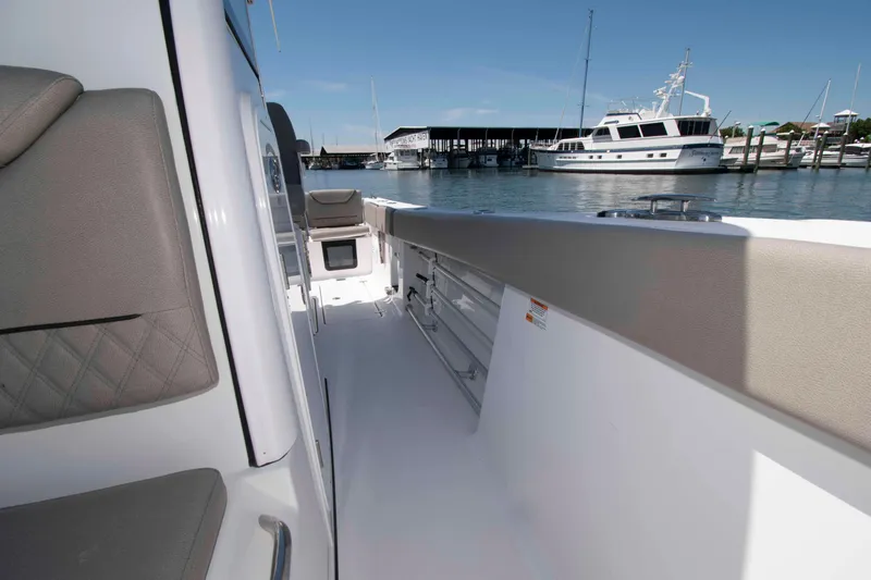 Slide: The Image of 2023 Sportsman Heritage 261 Center Console boat docked at marina, interior view. - 14