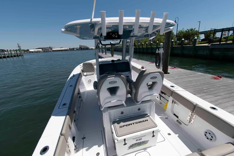 Slide: The Image of 2023 Sportsman Heritage 261 Center Console boat docked by the water. - 3