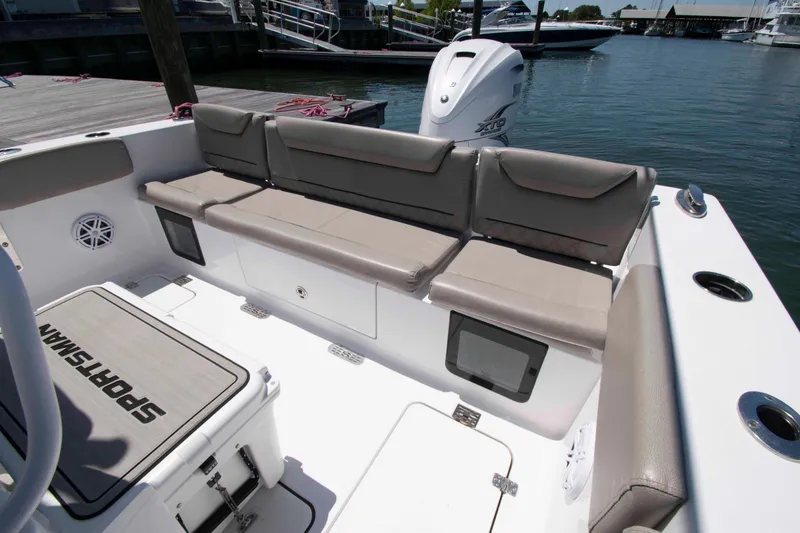 Slide: The Image of 2023 Sportsman Heritage 261 Center Console boat with cushioned seating and storage compartments. - 4