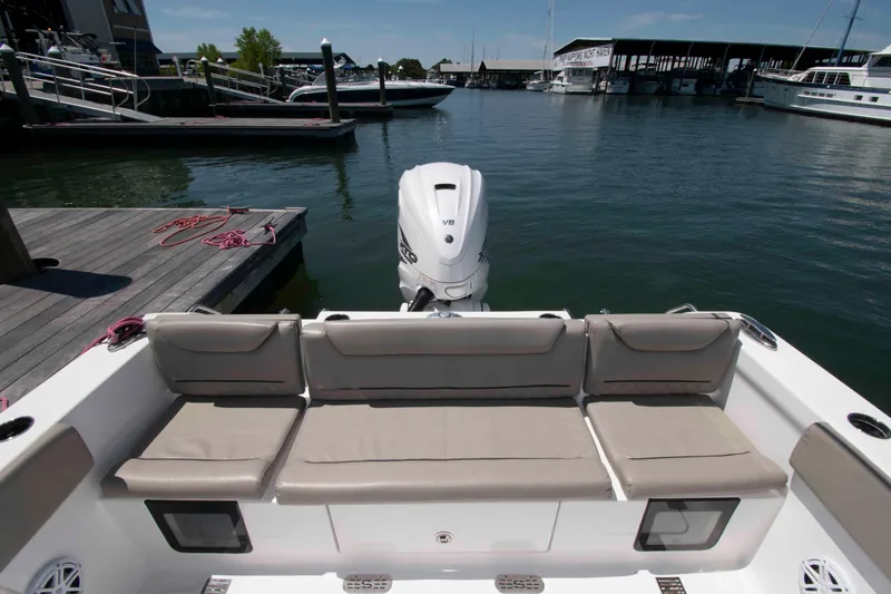 Slide: The Image of 2023 Sportsman Heritage 261 Center Console at marina, featuring comfortable seating and powerful engine. - 5