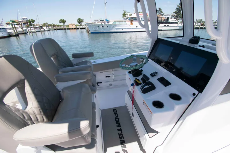 Slide: The Image of 2023 Sportsman Heritage 261 Center Console boat interior with helm and seating. - 6