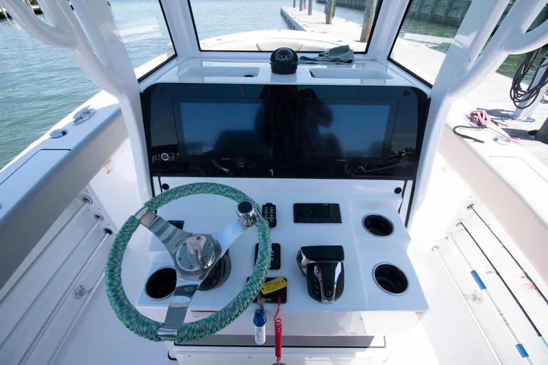 Slide: The Image of 2023 Sportsman Heritage 261 Center Console helm with steering wheel and navigation screens. - 7