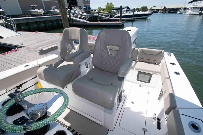 Slide: The Image of 2023 Sportsman Heritage 261 Center Console boat interior with helm and seating. - 9