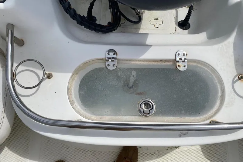 Slide: The Image of 2010 Key West 211 Center Console boat's livewell with stainless steel railing. - 12