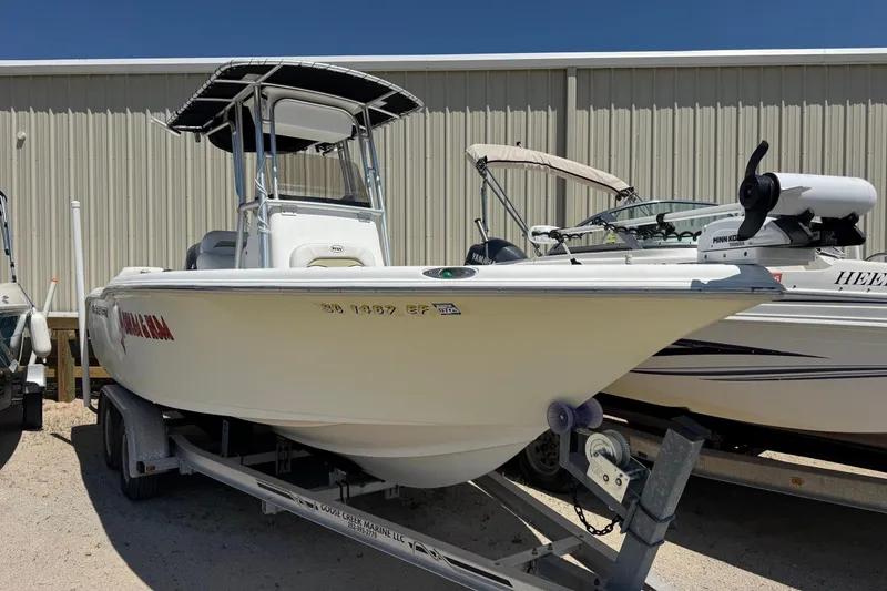 Slide: The Image of 2010 Key West 211 Center Console boat on trailer, parked outdoors. - 2