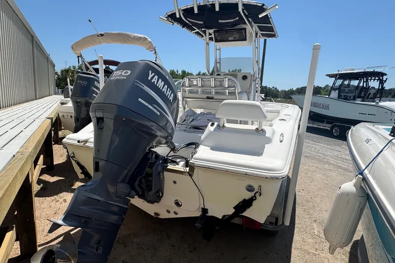 Slide: The Image of 2010 Key West 211 Center Console boat with Yamaha outboard motor, docked outdoors. - 3