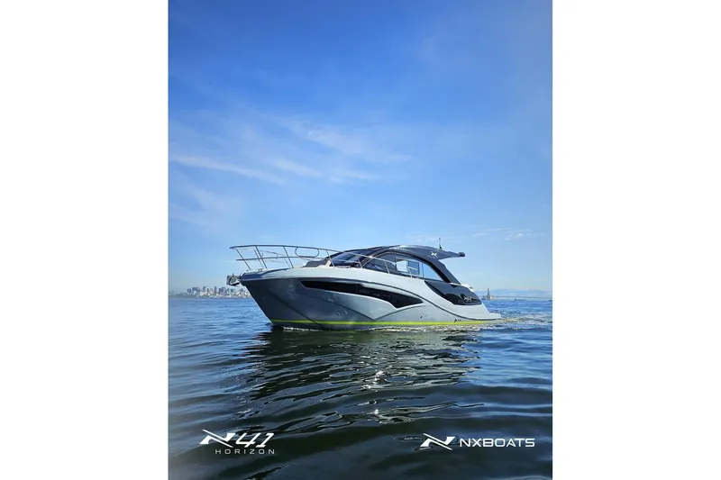 Slide: The Image of 2026 NX Boats NX41 HORIZON cruising on calm waters under a clear blue sky. - 14