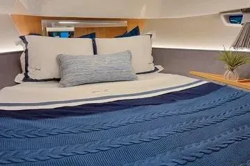 Slide: The Image of Luxurious cabin interior of 2026 NX Boats NX41 HORIZON with elegant bedding. - 6