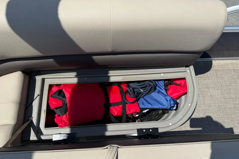 Slide: The Image of Storage compartment in 2023 Sun Tracker Bass Buggy 16 XL Select with life jackets and rope. - 17